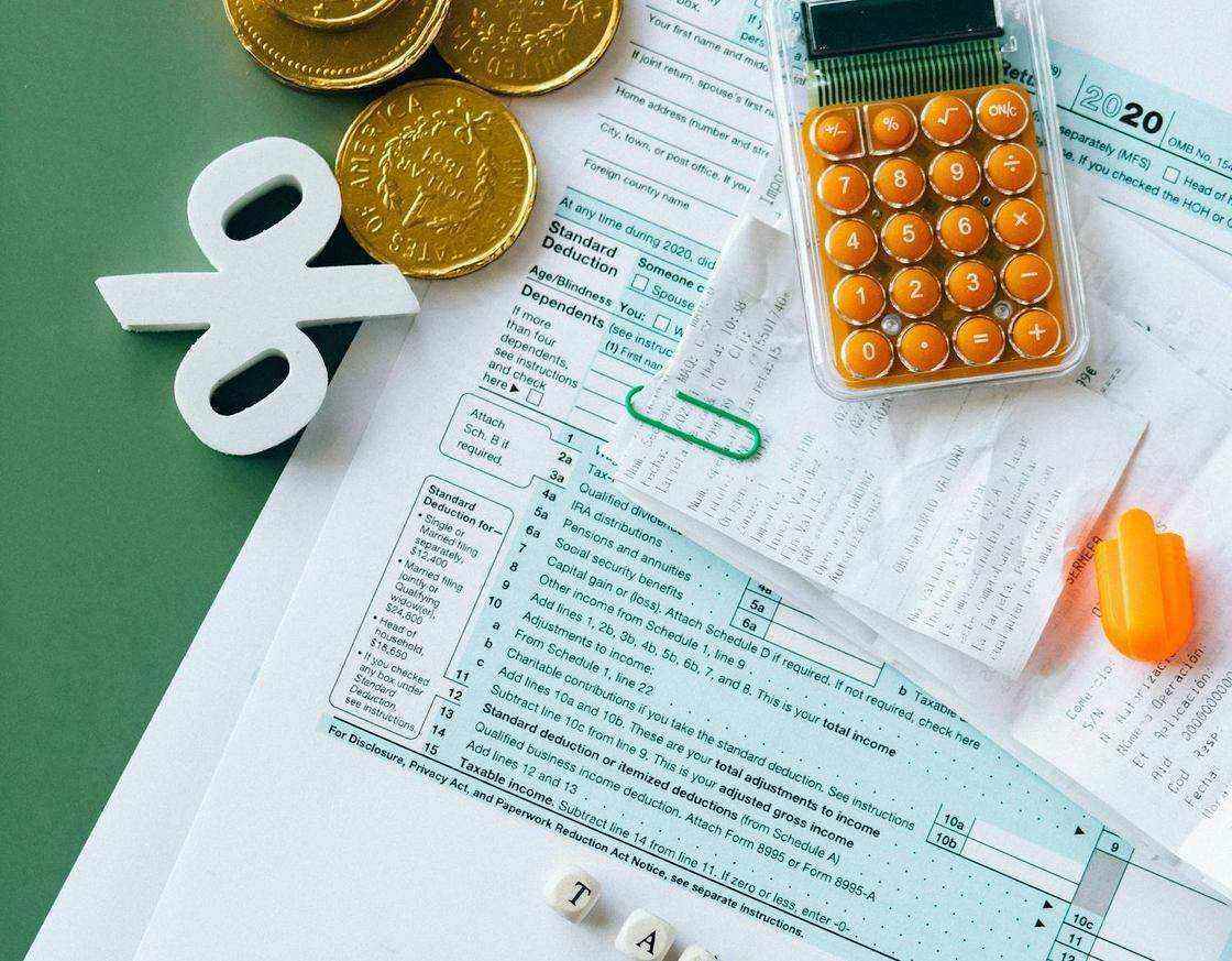 Tax forms and calculator arranged for record review
